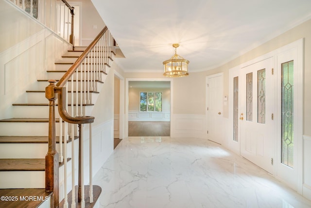 245 Borden Rd, Middletown, NJ 07748 - foyer featuring a decorative wall, stairway, a wainscoted wall, a chandelier, and marble tiled flooring