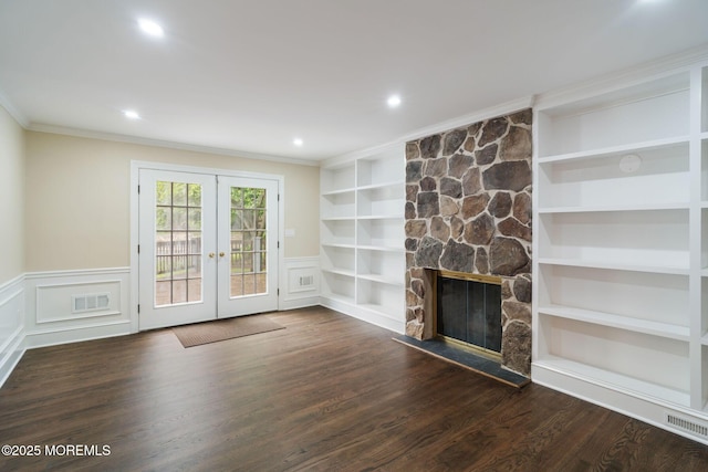 245 Borden Rd, Middletown, NJ 07748 - unfurnished living room featuring french doors, crown molding, built in features, wood finished floors, and a stone fireplace