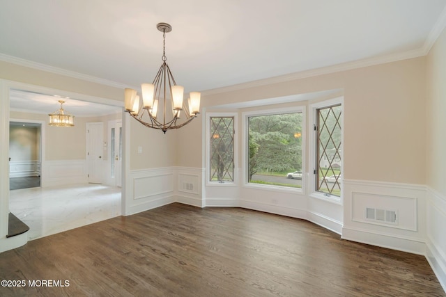 245 Borden Rd, Middletown, NJ 07748 - unfurnished dining area featuring a chandelier, a wainscoted wall, wood finished floors, crown molding, and a decorative wall