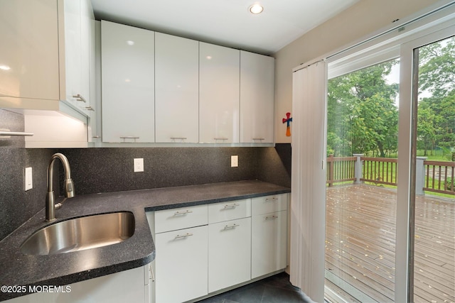 245 Borden Rd, Middletown, NJ 07748 - kitchen featuring a sink, dark countertops, white cabinetry, and recessed lighting