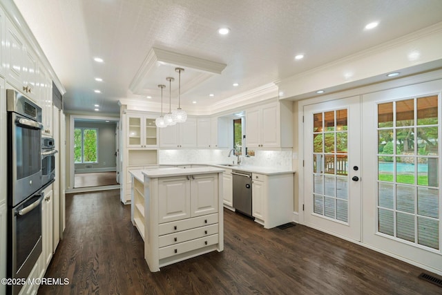245 Borden Rd, Middletown, NJ 07748 - kitchen featuring ornamental molding, stainless steel appliances, light countertops, white cabinets, and french doors