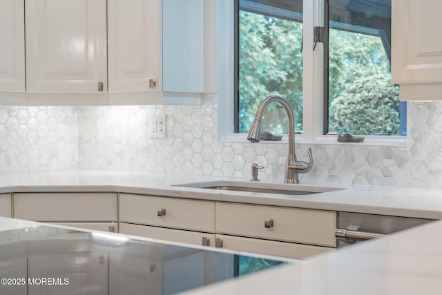 245 Borden Rd, Middletown, NJ 07748 - kitchen featuring a sink, light countertops, white cabinets, and backsplash