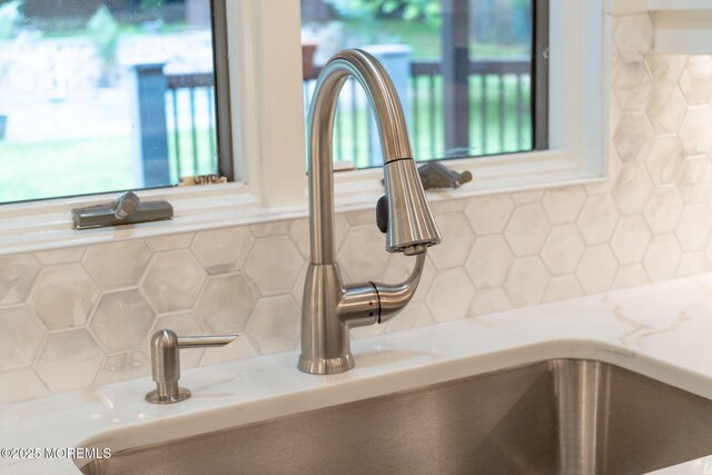 245 Borden Rd, Middletown, NJ 07748 - kitchen view of a sink, backsplash, and light stone counters