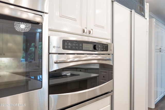 245 Borden Rd, Middletown, NJ 07748 - kitchen with white cabinets and paneled refrigerator