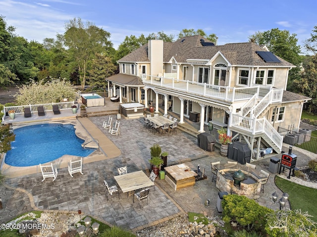 1413 Gully Rd, Wall, NJ 07719 - rear view of property with outdoor dining space, a patio area, a chimney, a jacuzzi, and an outdoor living space with a fire pit