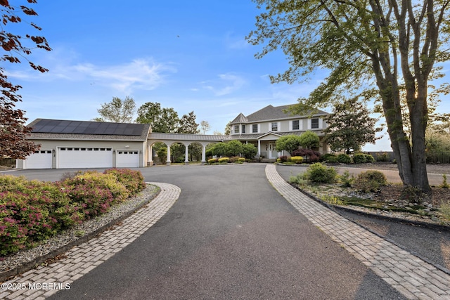 1413 Gully Rd, Wall, NJ 07719 - view of front of house featuring a garage, solar panels, and driveway