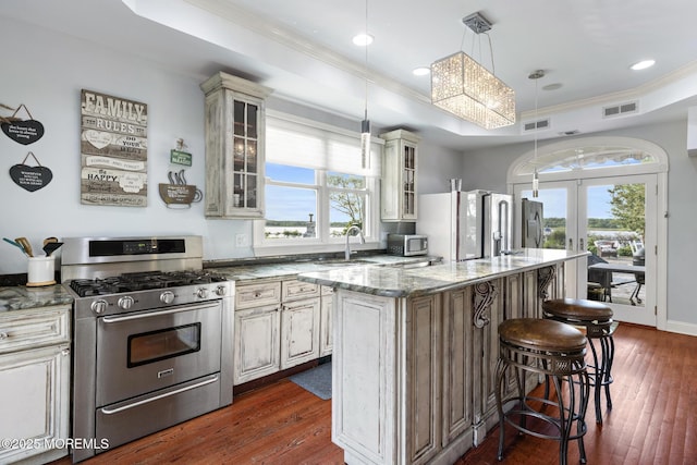 1413 Gully Rd, Wall, NJ 07719 - kitchen featuring stainless steel appliances, french doors, dark wood-type flooring, a kitchen breakfast bar, and light stone countertops