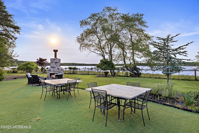 1413 Gully Rd, Wall, NJ 07719 - view of grassy yard featuring outdoor dining space, a lit fireplace, and a water view