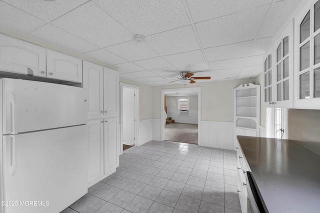 105 Cedar Grove Rd, Toms River, NJ 08753 - kitchen featuring freestanding refrigerator, a drop ceiling, wainscoting, white cabinets, and glass insert cabinets