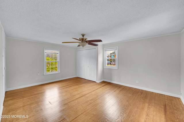 105 Cedar Grove Rd, Toms River, NJ 08753 - unfurnished bedroom featuring wood finished floors, multiple windows, a textured ceiling, a closet, and crown molding