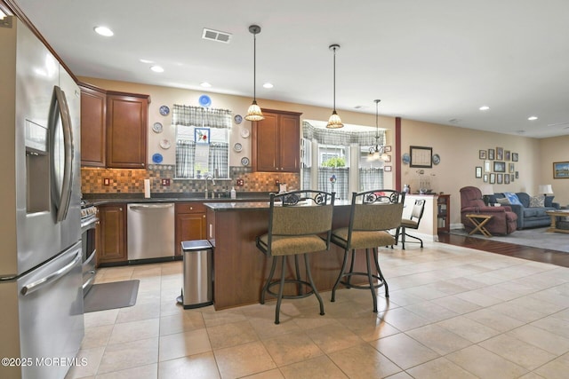 21 Blyth Ln, Jackson, NJ 08527 - kitchen featuring appliances with stainless steel finishes, dark countertops, open floor plan, decorative backsplash, and recessed lighting