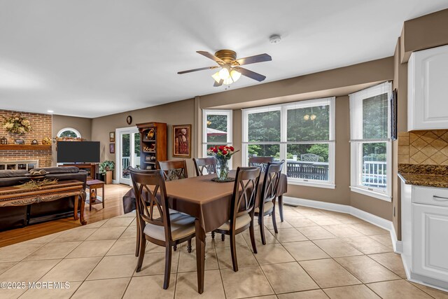 10 Cheryl Ln, Millstone, NJ 08510 - dining area with ceiling fan, light tile patterned flooring, and a fireplace