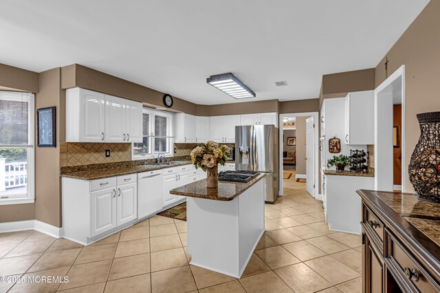 10 Cheryl Ln, Millstone, NJ 08510 - kitchen featuring white dishwasher, stainless steel refrigerator with ice dispenser, dark stone countertops, a center island, and white cabinetry