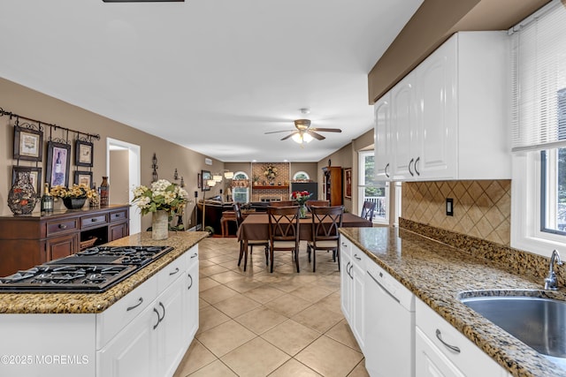 10 Cheryl Ln, Millstone, NJ 08510 - kitchen with black gas stovetop, white dishwasher, a ceiling fan, decorative backsplash, and light tile patterned flooring