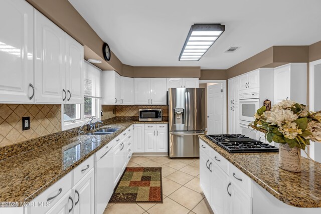 10 Cheryl Ln, Millstone, NJ 08510 - kitchen with stainless steel appliances, dark stone counters, and white cabinetry