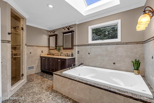 10 Cheryl Ln, Millstone, NJ 08510 - full bathroom with tile walls, a skylight, double vanity, a bath, and a shower stall