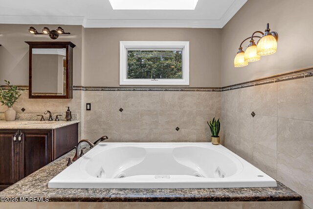 10 Cheryl Ln, Millstone, NJ 08510 - full bathroom with tile walls, a skylight, a jetted tub, vanity, and ornamental molding