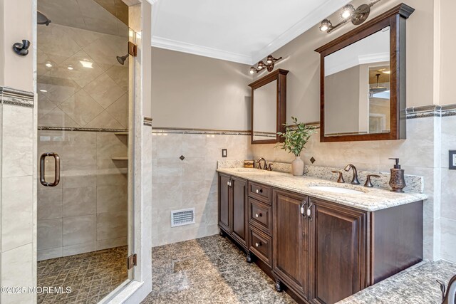 10 Cheryl Ln, Millstone, NJ 08510 - bathroom with tile walls, double vanity, a stall shower, ornamental molding, and wainscoting