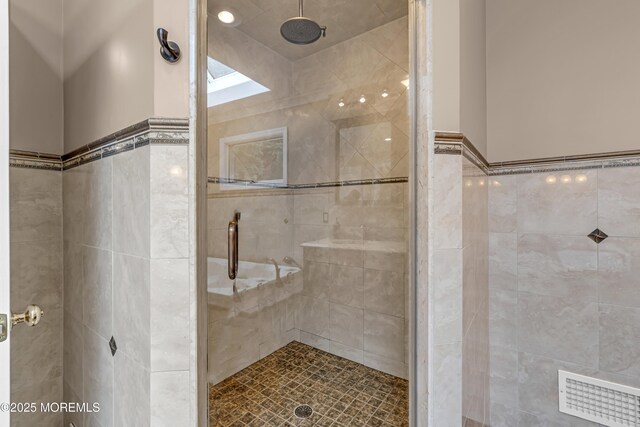 10 Cheryl Ln, Millstone, NJ 08510 - full bathroom featuring tile walls, a shower stall, and a wainscoted wall