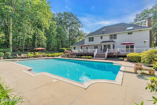 10 Cheryl Ln, Millstone, NJ 08510 - swimming pool featuring a wooden deck, a patio, and a diving board