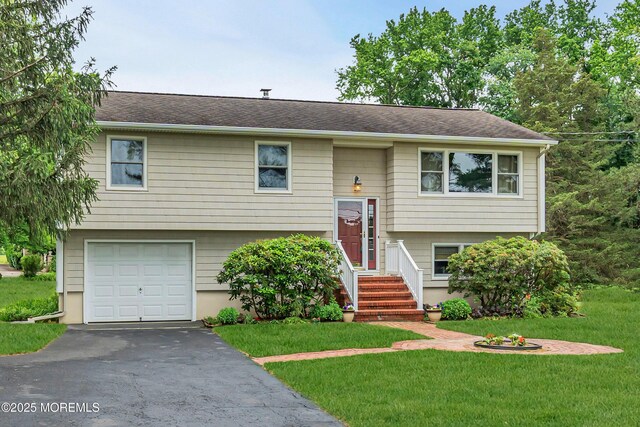 136 Iron Ore Rd, Manalapan, NJ 07726 - bi-level home with a garage, a front yard, and driveway