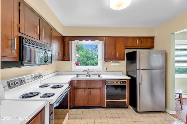 136 Iron Ore Rd, Manalapan, NJ 07726 - kitchen featuring black appliances, light tile patterned flooring, and light countertops