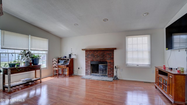 21 Parkview Way, Manalapan, NJ 07726 - living room featuring vaulted ceiling, plenty of natural light, light wood-style floors, a brick fireplace, and recessed lighting