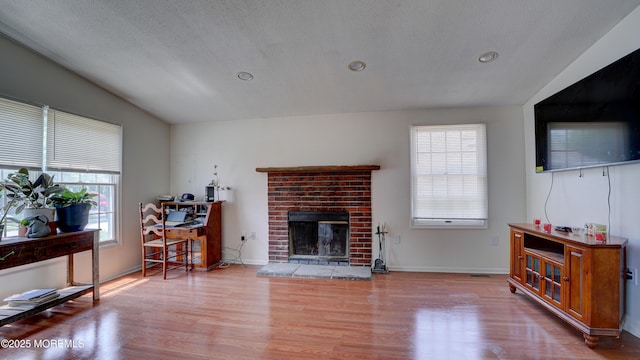 21 Parkview Way, Manalapan, NJ 07726 - living area featuring wood finished floors, healthy amount of natural light, a fireplace, recessed lighting, and lofted ceiling