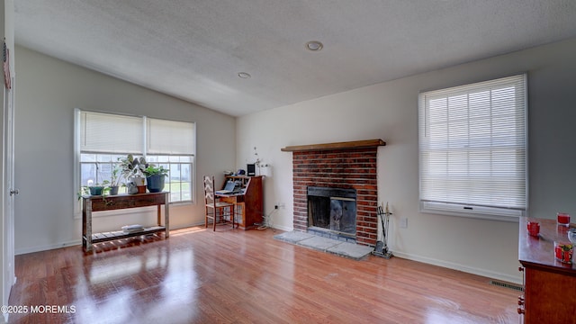 21 Parkview Way, Manalapan, NJ 07726 - living area with lofted ceiling, wood finished floors, and a fireplace