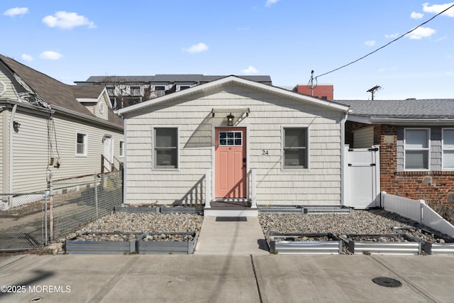 24 Highland Ave, Keansburg, NJ 07734 - view of front of property with a vegetable garden, a gate, and a chimney