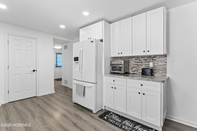 24 Highland Ave, Keansburg, NJ 07734 - kitchen featuring white fridge with ice dispenser, white cabinets, recessed lighting, baseboards, and light wood-type flooring