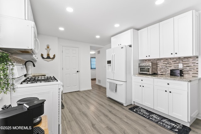 24 Highland Ave, Keansburg, NJ 07734 - kitchen featuring white appliances, white cabinetry, tasteful backsplash, light wood-style floors, and recessed lighting