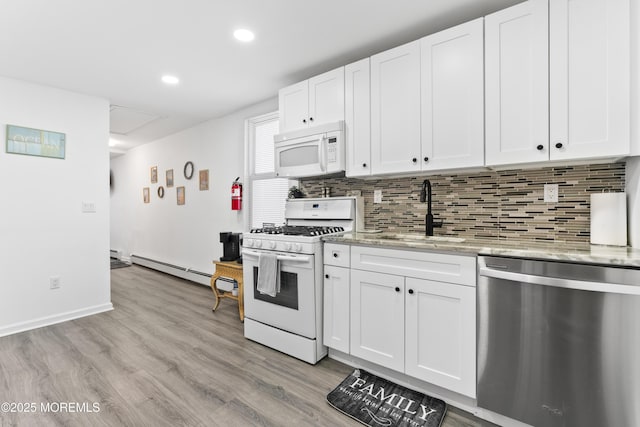 24 Highland Ave, Keansburg, NJ 07734 - kitchen with white appliances, a sink, a baseboard radiator, decorative backsplash, and light wood finished floors