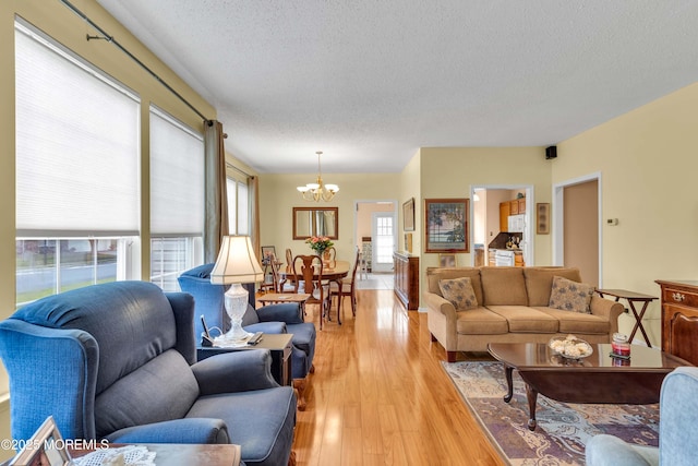 143 Sylvan Lake Blvd, Bayville, NJ 08721 - living area with a chandelier, a textured ceiling, and light wood-style flooring
