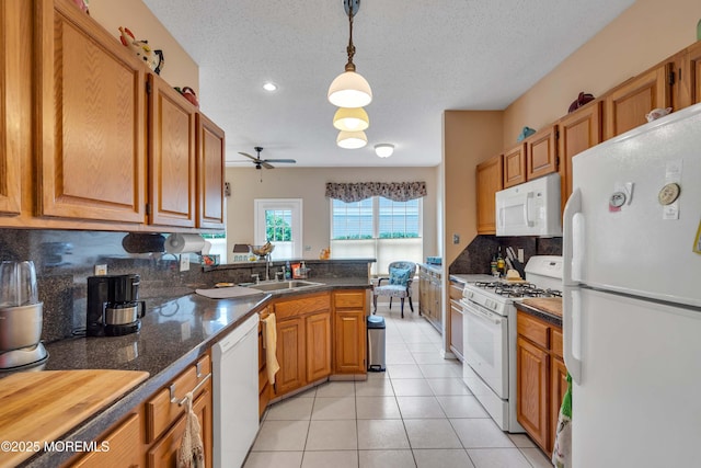 143 Sylvan Lake Blvd, Bayville, NJ 08721 - kitchen featuring white appliances, a ceiling fan, backsplash, light tile patterned floors, and dark countertops