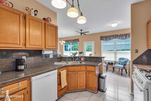 143 Sylvan Lake Blvd, Bayville, NJ 08721 - kitchen with white appliances, a peninsula, light tile patterned floors, decorative backsplash, and a ceiling fan
