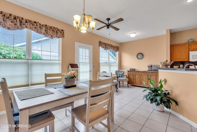 143 Sylvan Lake Blvd, Bayville, NJ 08721 - dining room featuring light tile patterned flooring, a chandelier, and a ceiling fan