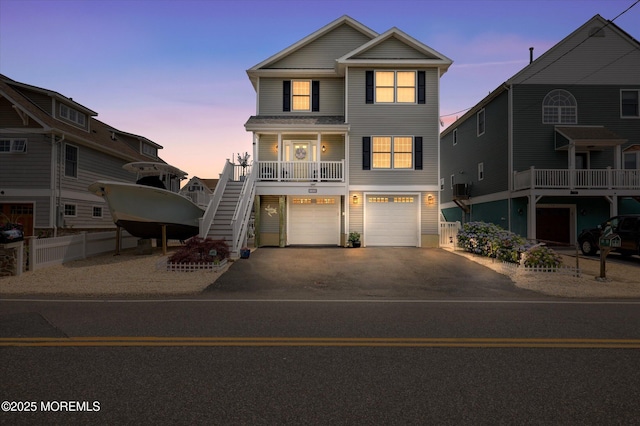 728 Drum Point Rd, Brick, NJ 08723 - coastal home with asphalt driveway, stairway, a garage, and covered porch