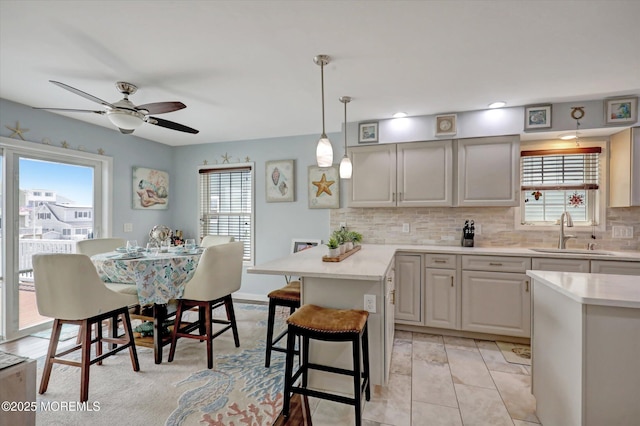 728 Drum Point Rd, Brick, NJ 08723 - kitchen featuring light countertops, a kitchen bar, decorative backsplash, ceiling fan, and recessed lighting