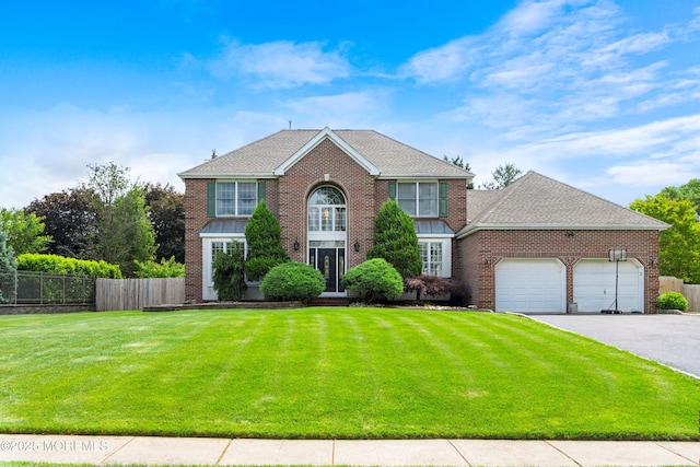 14 Tuscan Dr, Freehold, NJ 07728 - view of front of property featuring an attached garage, asphalt driveway, brick siding, and a shingled roof