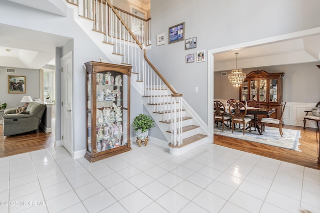 14 Tuscan Dr, Freehold, NJ 07728 - entrance foyer with tile patterned floors, stairway, a towering ceiling, and a chandelier