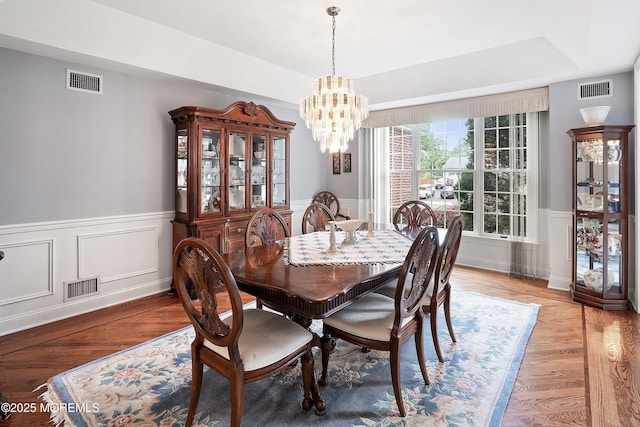 14 Tuscan Dr, Freehold, NJ 07728 - dining space featuring a chandelier, a wainscoted wall, a raised ceiling, and light wood-style flooring