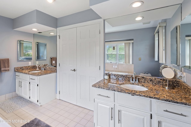 14 Tuscan Dr, Freehold, NJ 07728 - full bathroom featuring two vanities, tile patterned floors, recessed lighting, and a tub to relax in