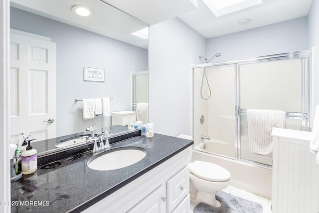 14 Tuscan Dr, Freehold, NJ 07728 - bathroom featuring vanity, toilet, a skylight, and shower / bath combination with glass door