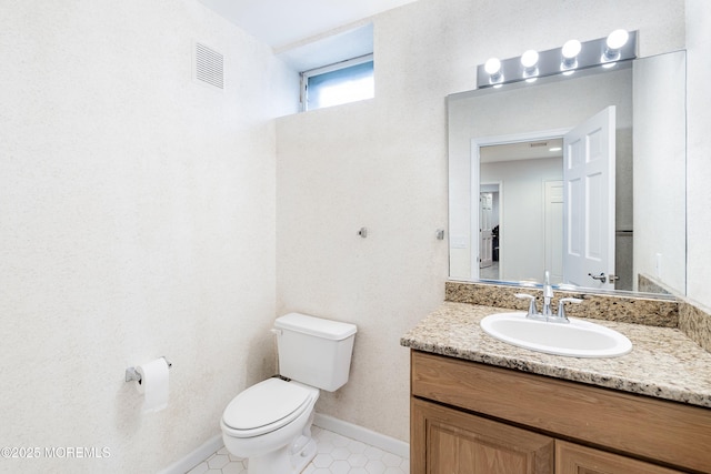 14 Tuscan Dr, Freehold, NJ 07728 - bathroom with toilet, vanity, baseboards, and tile patterned floors