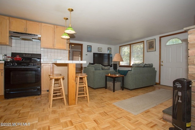 1801 Serpentine Dr, Forked River, NJ 08731 - kitchen featuring gas stove, under cabinet range hood, tile countertops, light brown cabinetry, and backsplash