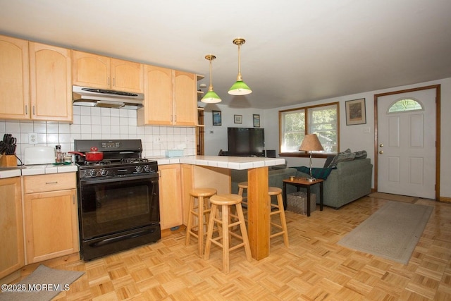 1801 Serpentine Dr, Forked River, NJ 08731 - kitchen featuring black range with gas cooktop, under cabinet range hood, light brown cabinets, tile countertops, and a peninsula