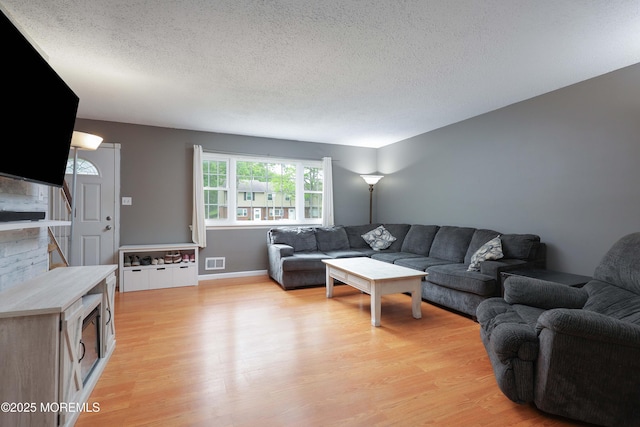 1184 Rachel Ct, Brick, NJ 08724 - living room with light wood-style floors, a textured ceiling, and stairway