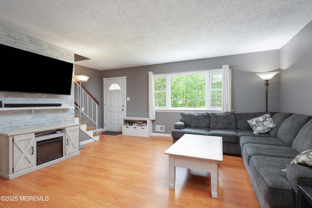 1184 Rachel Ct, Brick, NJ 08724 - living room featuring light wood-type flooring, a textured ceiling, and stairway