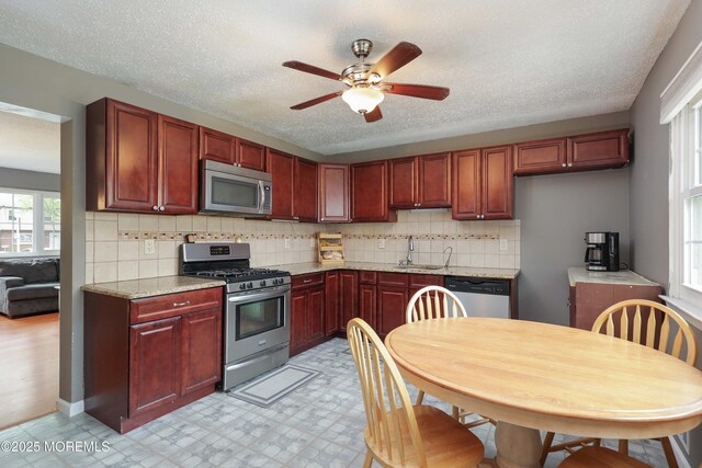 1184 Rachel Ct, Brick, NJ 08724 - kitchen featuring appliances with stainless steel finishes, a sink, reddish brown cabinets, ceiling fan, and light floors